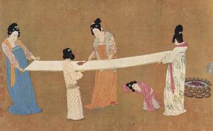 Ancient Chinese court ladies inspecting silk fabric