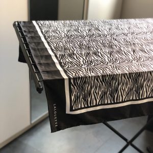 Silk scarf air drying on a drying rack