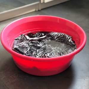 Silk scarf soaking in soapy water