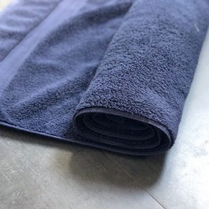 Wet silk scarf rolled in a towel to dry